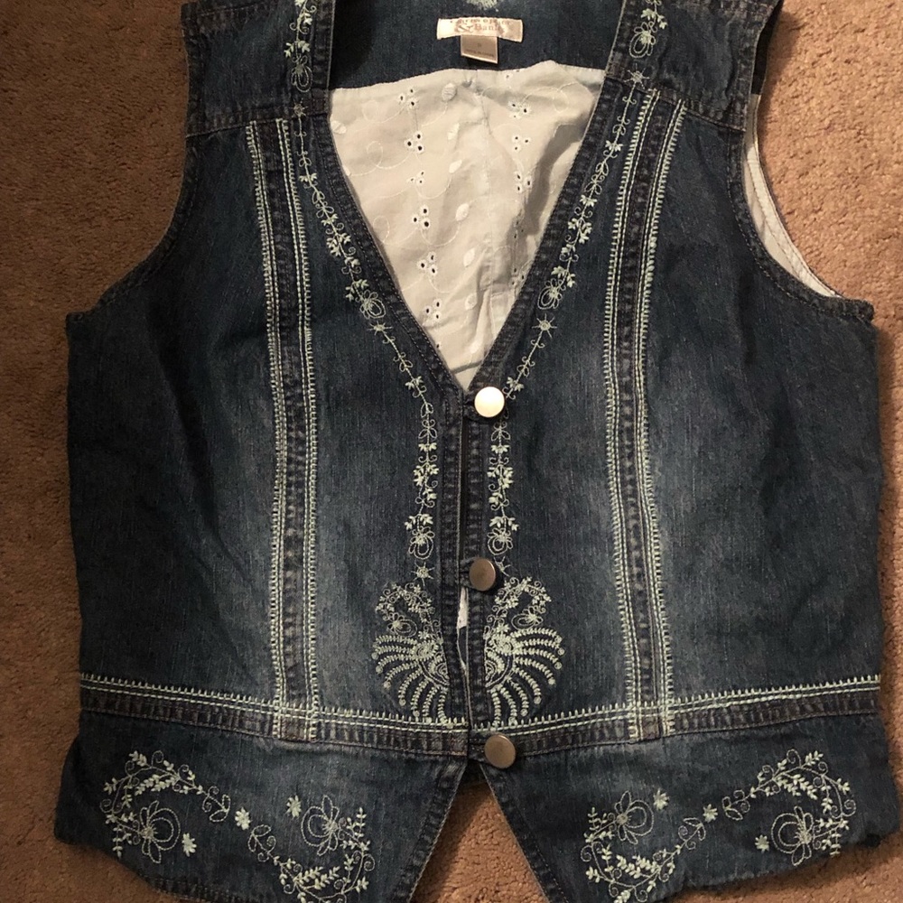 This embroidered jean vest is great for layering and is a size Small.